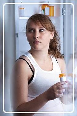 furtive girl at medicine cabinet